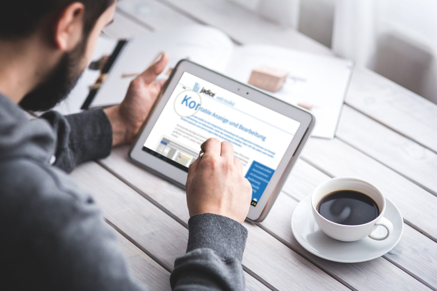Mann nutzt Tablet zur Dokumentenanzeige mit jadice web toolkit